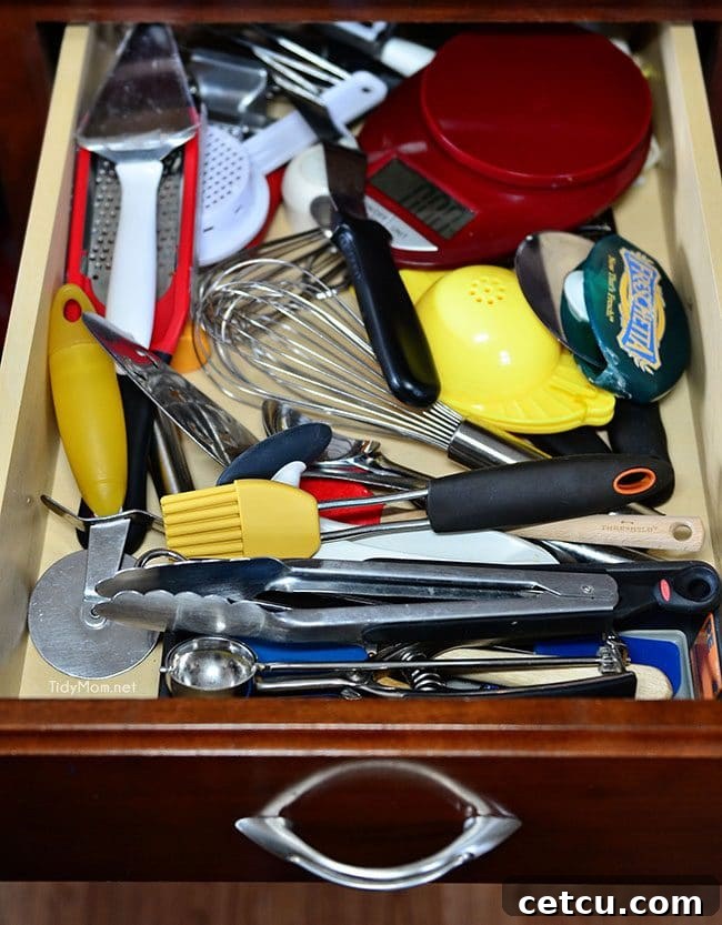 Smart Kitchen Drawer Solutions 3 Before: Messy kitchen tool drawer needing organization at TidyMom.net