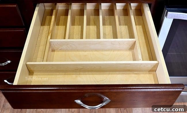 Smart Kitchen Drawer Solutions 6 Adding a cutlery divider for kitchen drawer organization at TidyMom.net