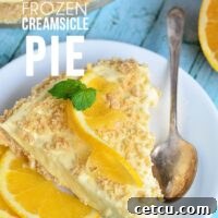 Delicious Frozen Creamsicle Pie with a vibrant orange and creamy white swirl, topped with golden cracker crumbs, perfect for a refreshing summer dessert.