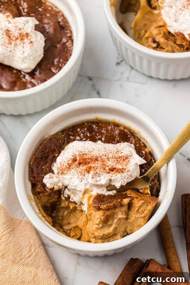 A single ramekin of Pumpkin Crème Brûlée, perfectly caramelized and ready to be served, highlighting its smooth custard texture.