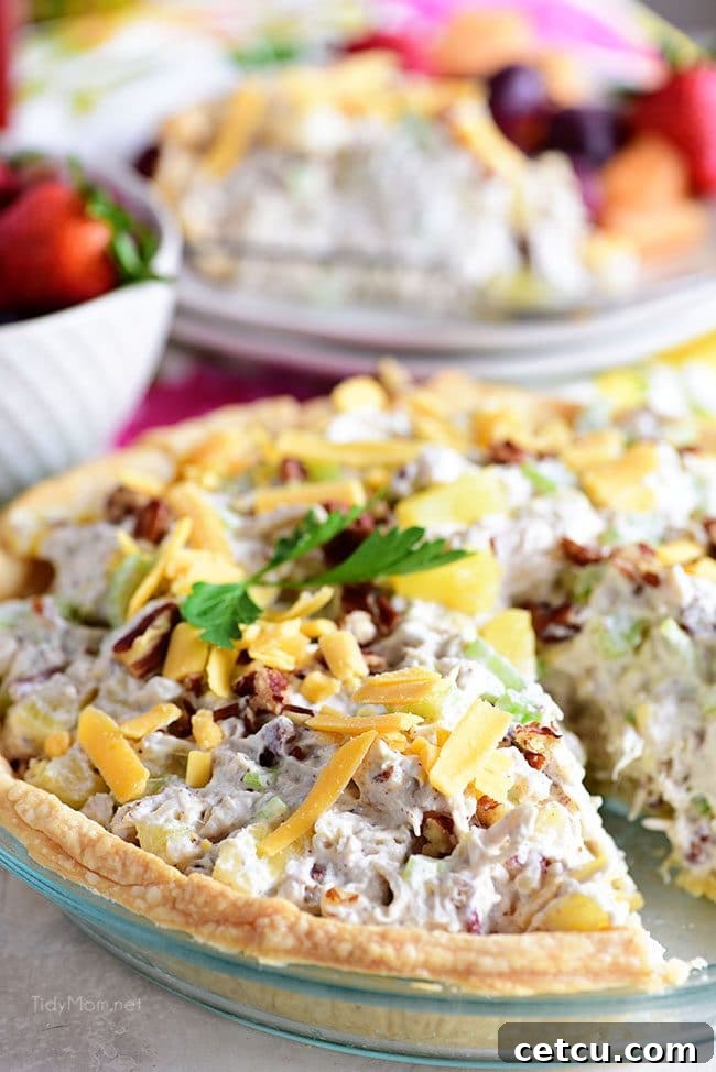 A delectable Pineapple Chicken Salad Pie, with one serving missing, showing off its generous filling and golden crust.