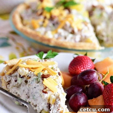 Pineapple Chicken Salad Pie on a plate with fresh fruit, ready to be served.