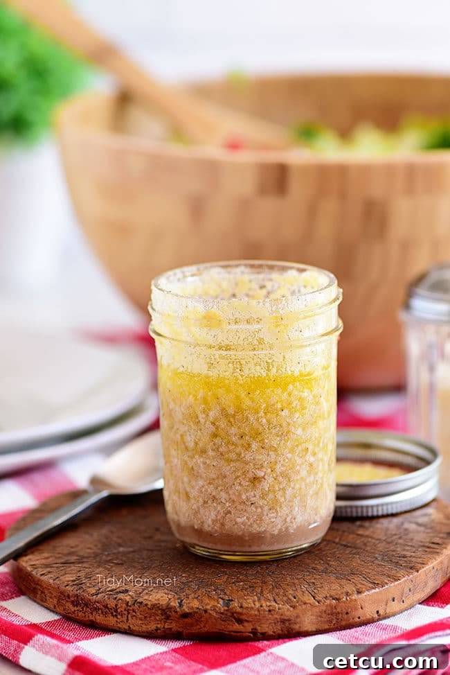 homemade zesty vinaigrette being prepared in a jar for an Italian salad, showcasing the olive oil, red wine vinegar, and other ingredients