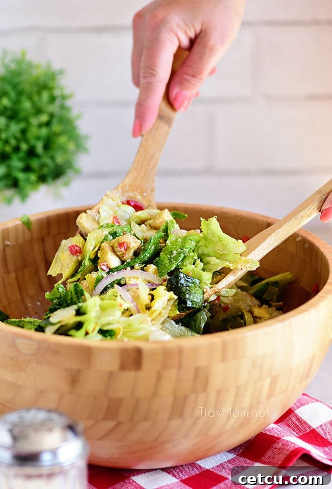 simple restaurant-style Italian Salad being tossed in a large bowl, ready for serving, showing a mix of fresh greens and vibrant vegetables