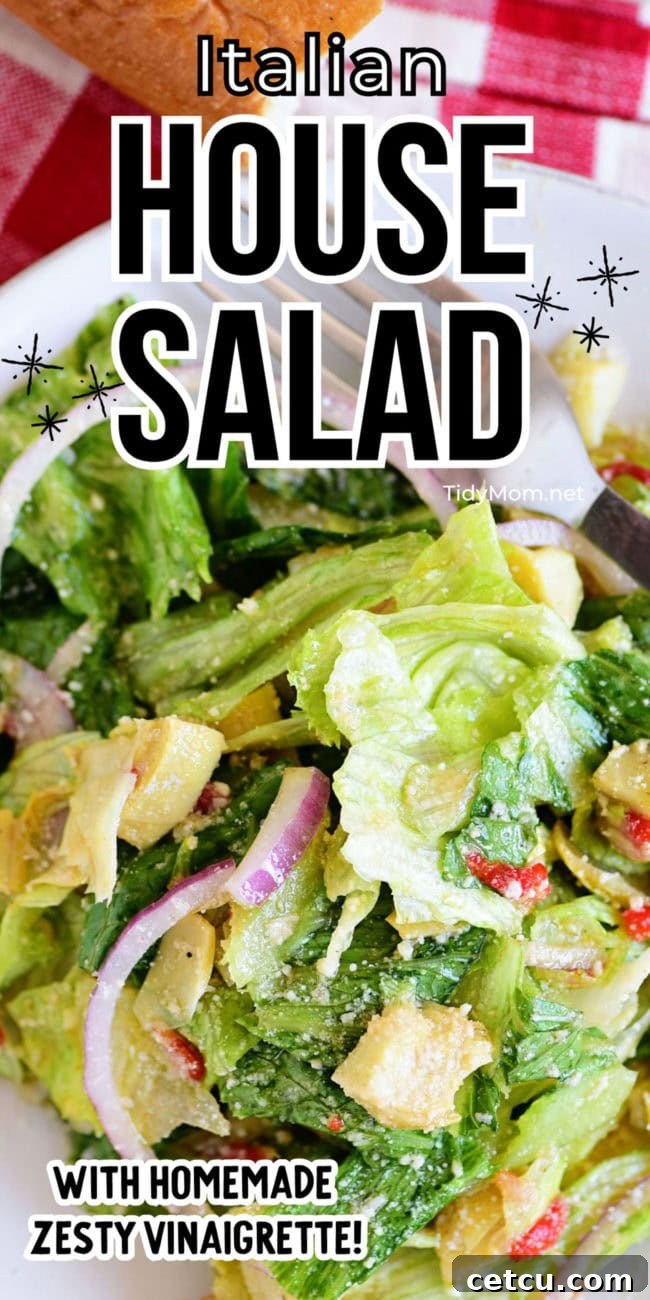 small plate of Italian house salad with a fork, ready to eat, showing crisp greens and vibrant toppings