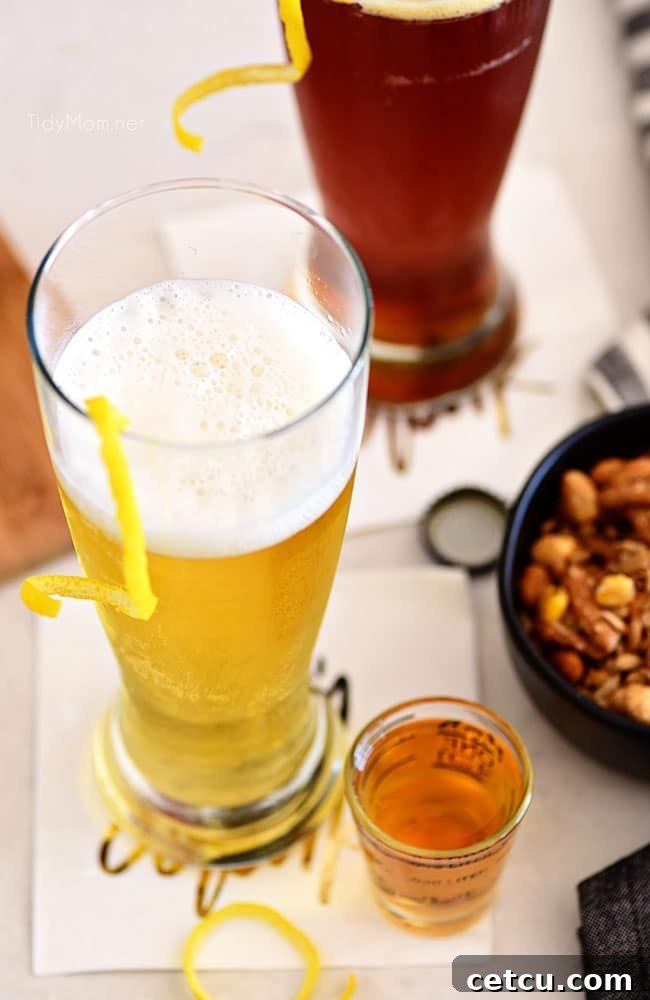 Boilermaker Blast Cocktail 6 beer cocktail with a lemon twist next to a bowl of nuts