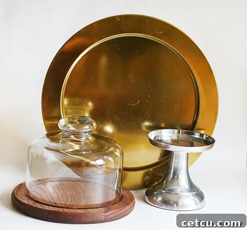 Before: Two shiny, reflective candlestick bases and a plate for a DIY cake stand project from the thrift store