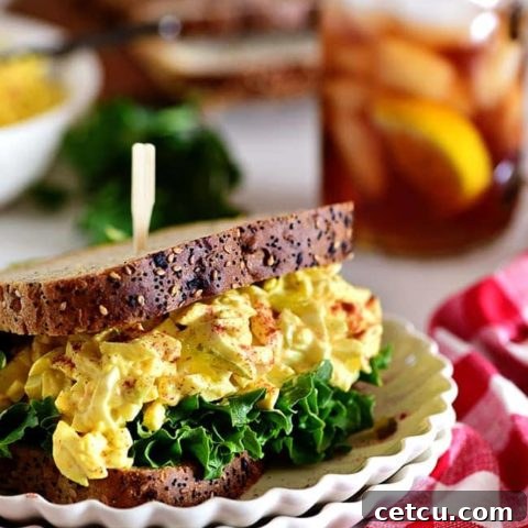 Classic egg salad sandwich on a stack of plates