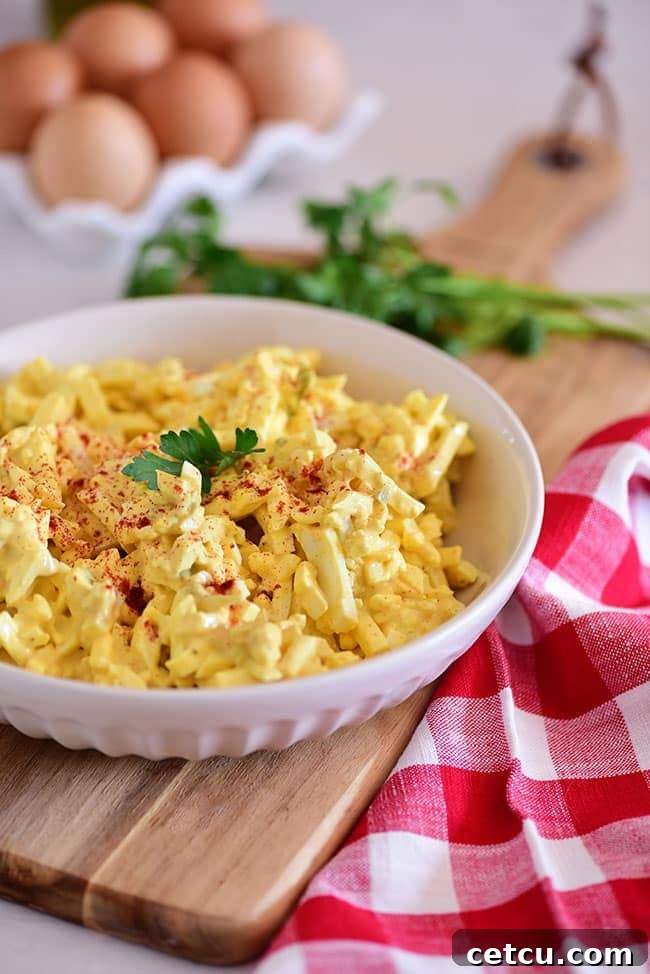 A bowl of creamy classic egg salad, perfectly mixed and ready for sandwiches.
