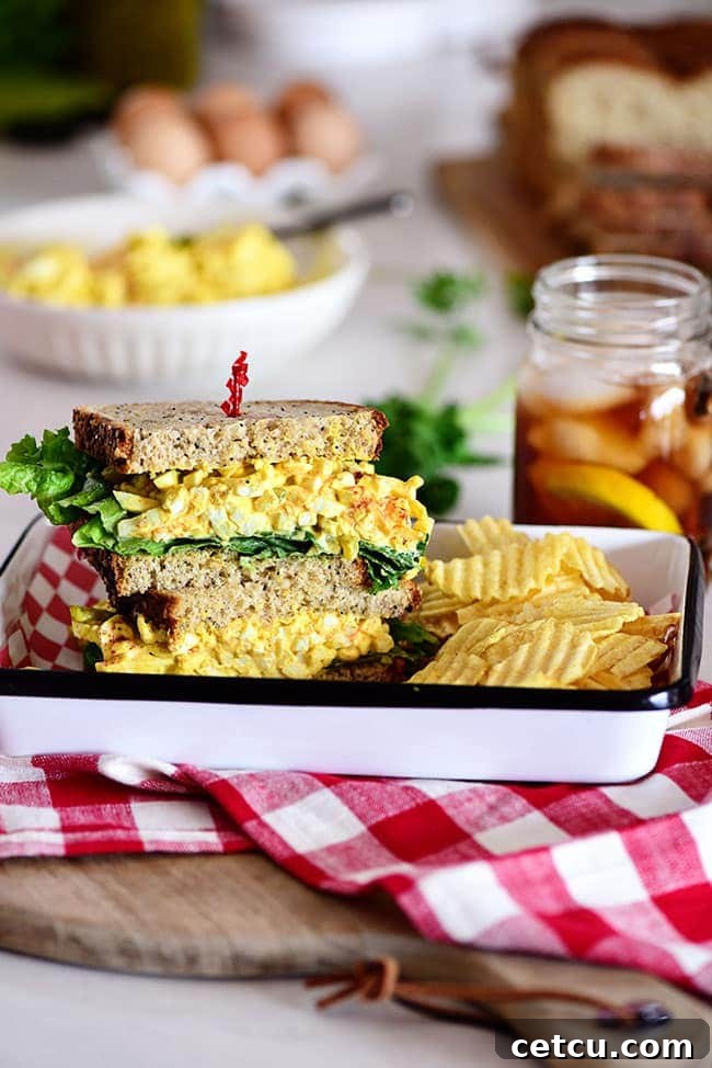 Close-up of a classic egg salad sandwich, showcasing its creamy texture and fresh lettuce.