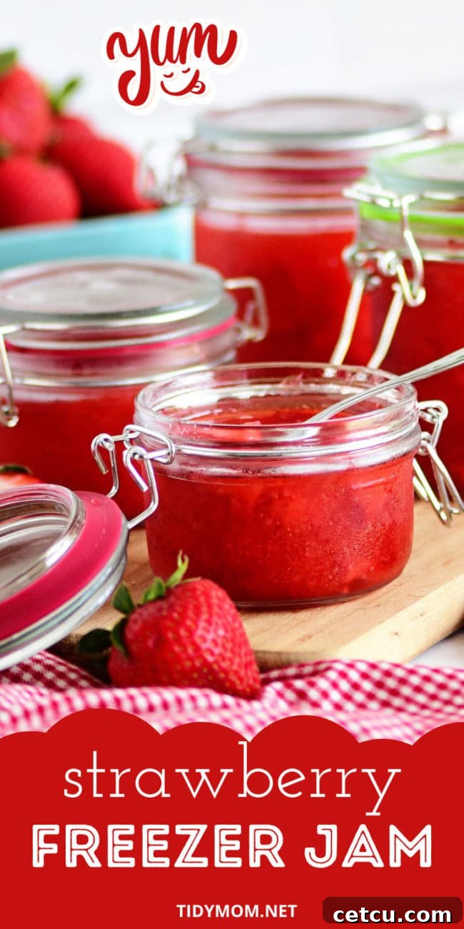 Several jars of homemade strawberry jam lined up, showcasing the beautiful color