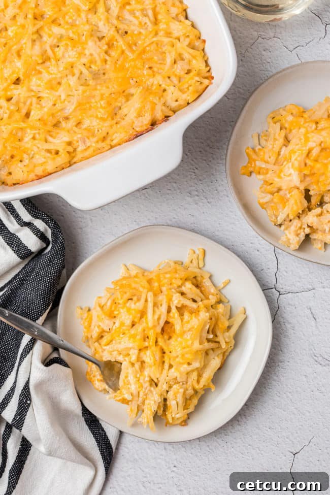 Loaded Cheesy Hashbrown Bake 3 two plates and a fork digging into hashbrown casserole