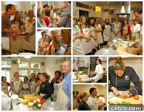 Watching Bloggers observe intently as a chef demonstrates cooking techniques in a professional kitchen.