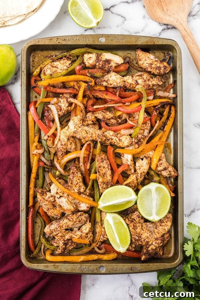Close-up of sheet pan fajitas with perfectly cooked chicken and vibrant bell peppers, ready to be served.