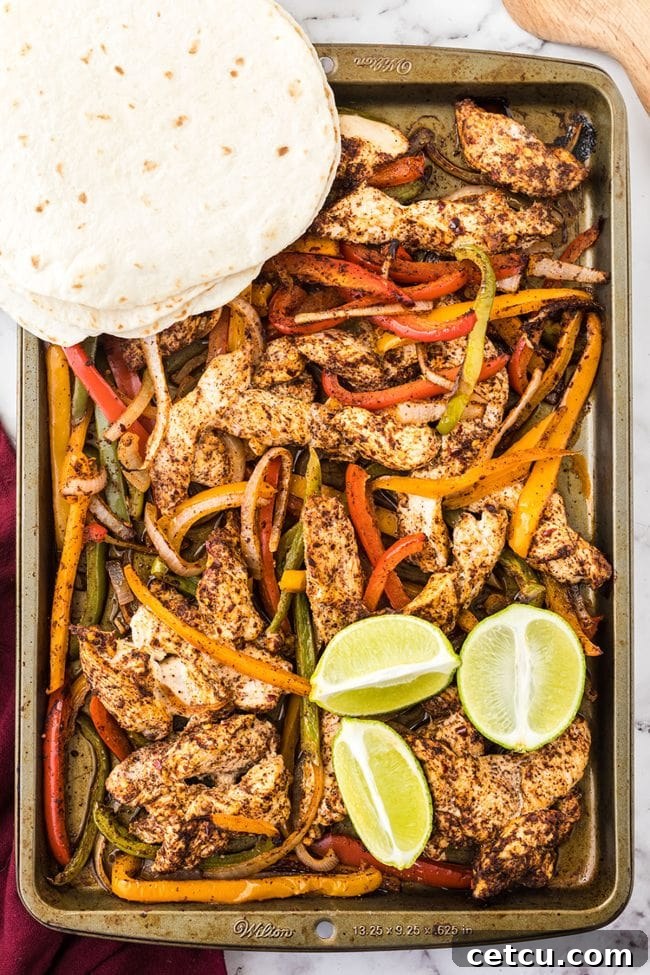 Sheet pan fajitas presented with warm flour tortillas, inviting a delicious meal.