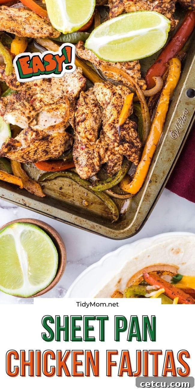 Beautifully roasted chicken and vegetables on a sheet pan, garnished with fresh lime, highlighting the ease of oven fajitas.
