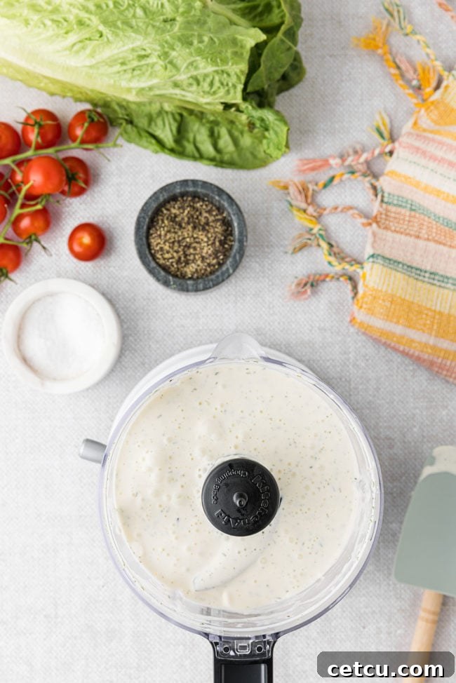 Making homemade dressing in a food processor, illustrating the blending process for a smooth BLT salad dressing.