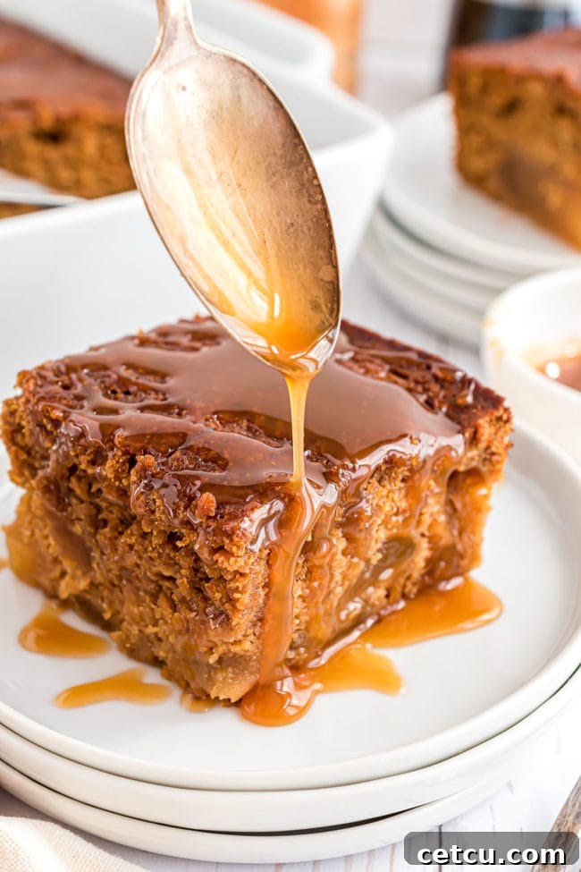Spiced Apple Gingerbread Cake 8 A close-up shot of a spoon expertly drizzling warm, golden caramel syrup over a generous slice of freshly baked apple gingerbread cake, creating a luxurious finish.