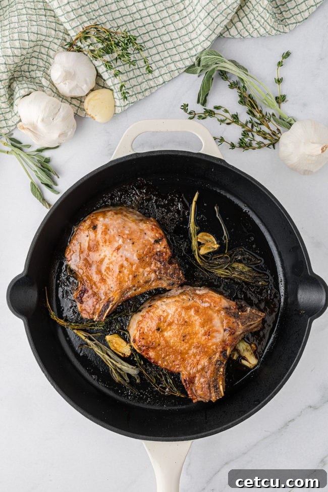 glazed pork chops in a cast iron skillet