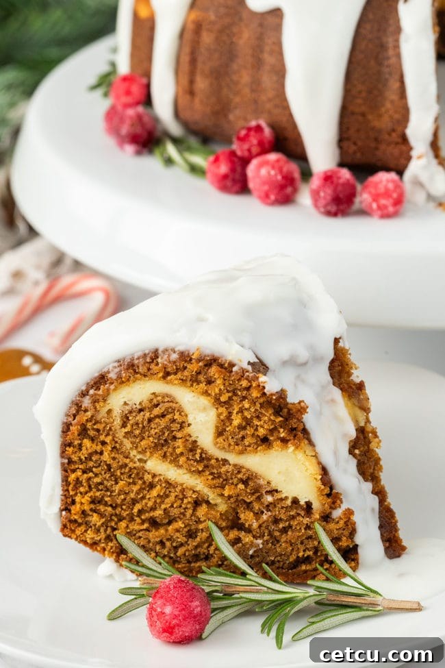 Gingerbread Bundt Cake with sugared cranberries and fresh rosemary sprigs