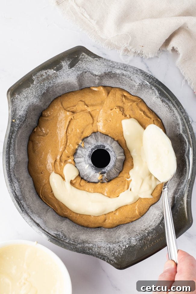 gingerbread cake batter and cheesecake filling in a bundt pan