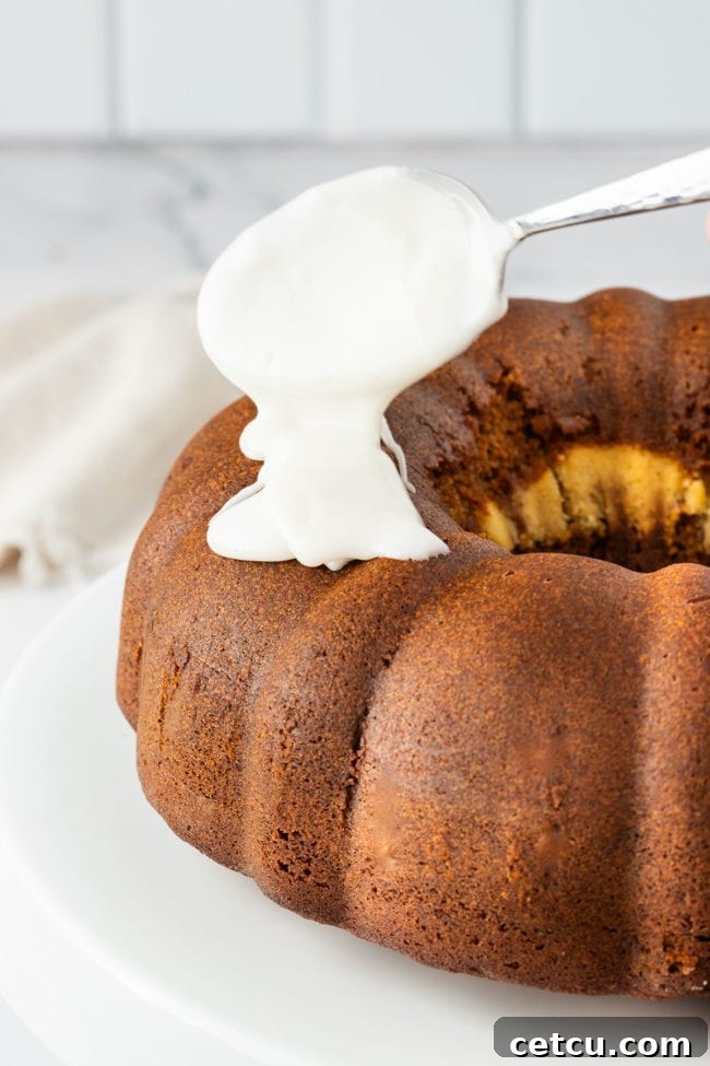drizzling glaze on a gingerbread bundt cake