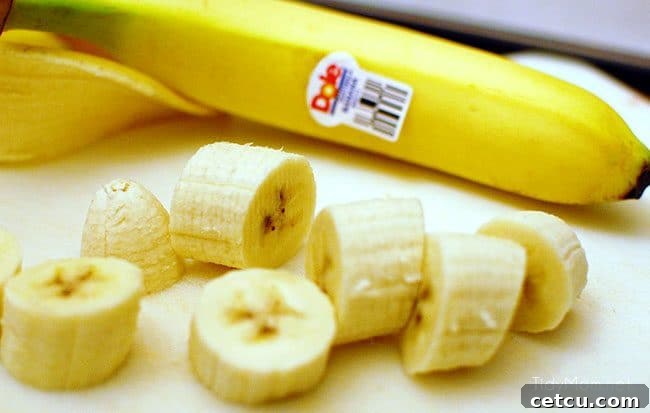 Perfectly sliced bananas ready to be coated for a frozen treat