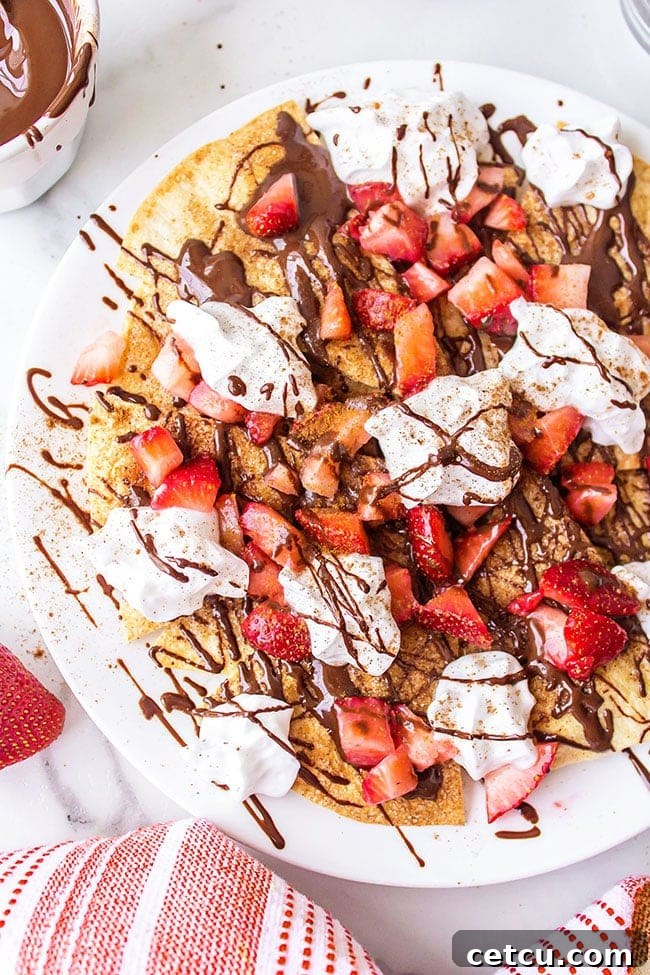 A festive platter of Chocolate Dessert Nachos featuring homemade baked cinnamon tortilla chips, ready to be enjoyed.