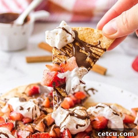 Delicious Chocolate Dessert Nachos with fresh strawberries and homemade baked cinnamon tortilla chips