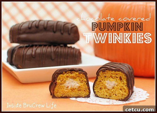Decorated Chocolate Covered Pumpkin Twinkies, adorned with fall-themed sprinkles and edible decorations on a white plate.