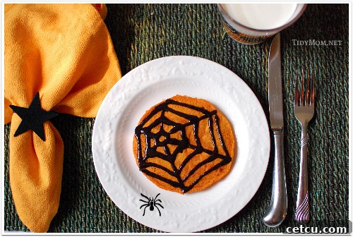 Spooky pumpkin pancakes with black cinnamon syrup for Halloween breakfast