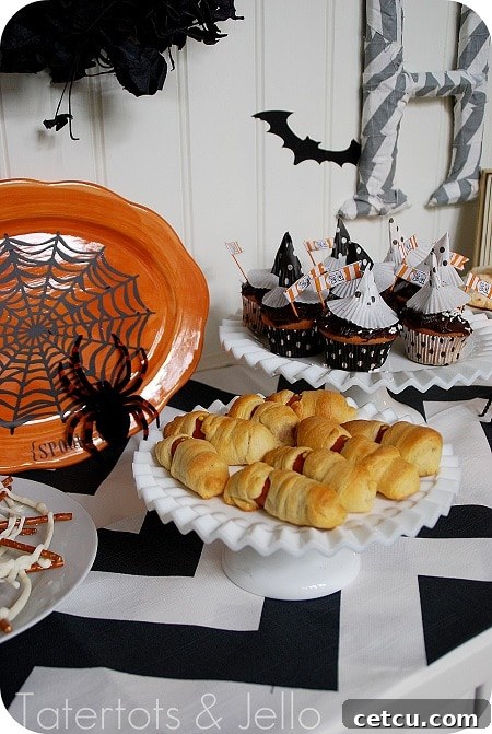 Halloween themed tea party setup with witch hats and treats