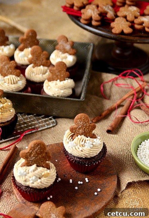 Beautifully decorated gingerbread cupcakes arranged on a festive platter, ready for holiday serving.
