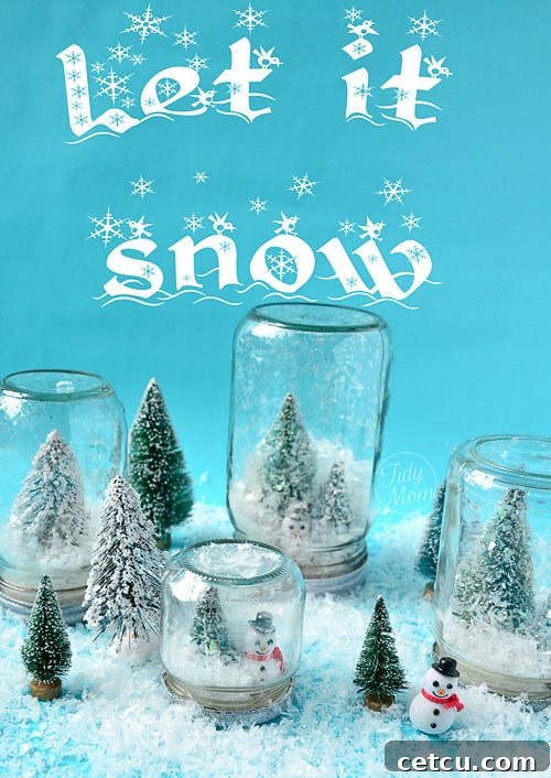 Three homemade waterless snow globes against a blue background, adorned with faux snow.