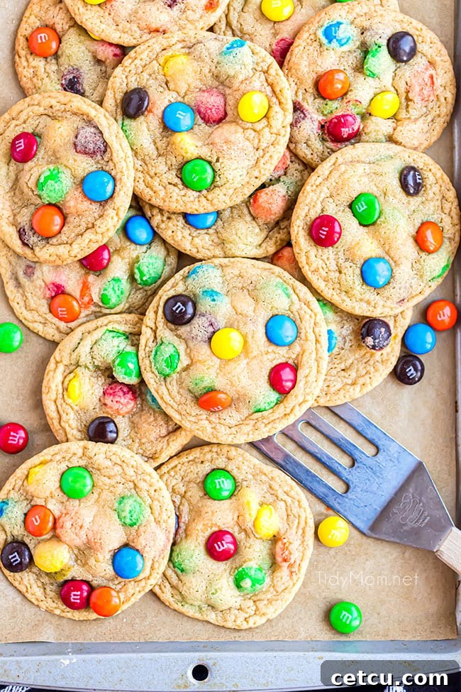 A delightful pile of easy M&M cookies casually arranged on a baking sheet, showcasing their colorful appeal.