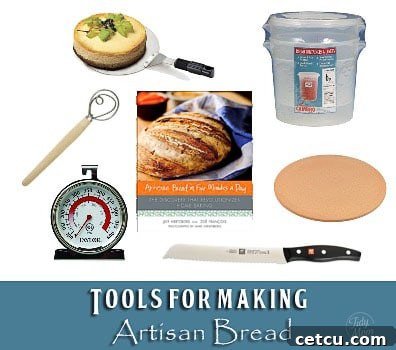 A collection of essential bread making tools including a pizza peel, dough container, pizza stone, bread knife, and whisk, laid out for a home baker.