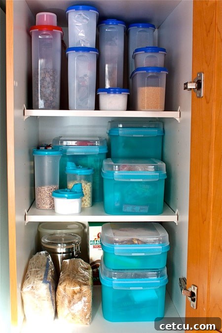 Organized kitchen pantry with various containers and modular storage solutions