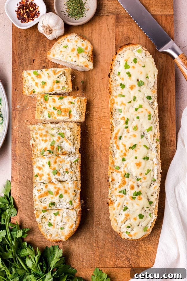 Two freshly baked loaves of golden-brown Cheesy Garlic Bread, perfectly toasted and ready to be enjoyed.
