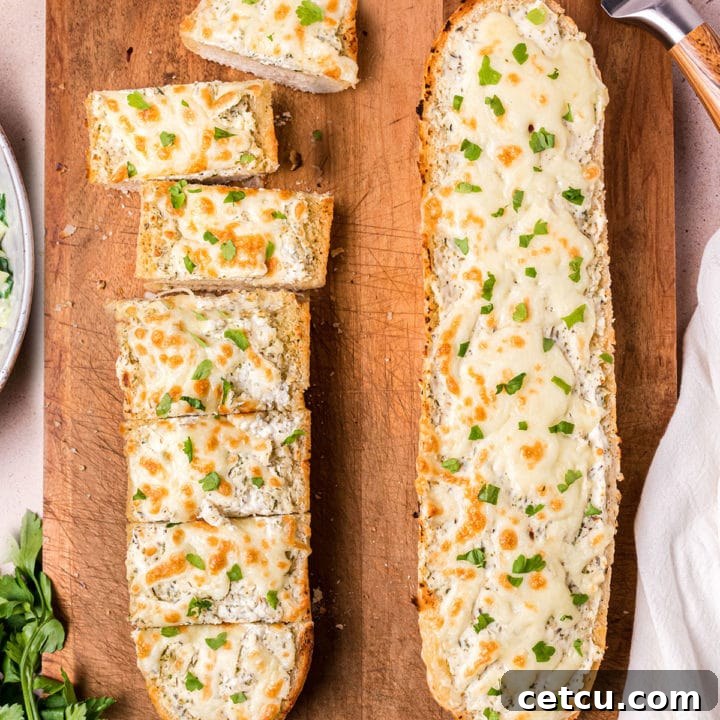 Two fresh baked loaves of Garlic Cheese Bread, golden and perfectly melted.