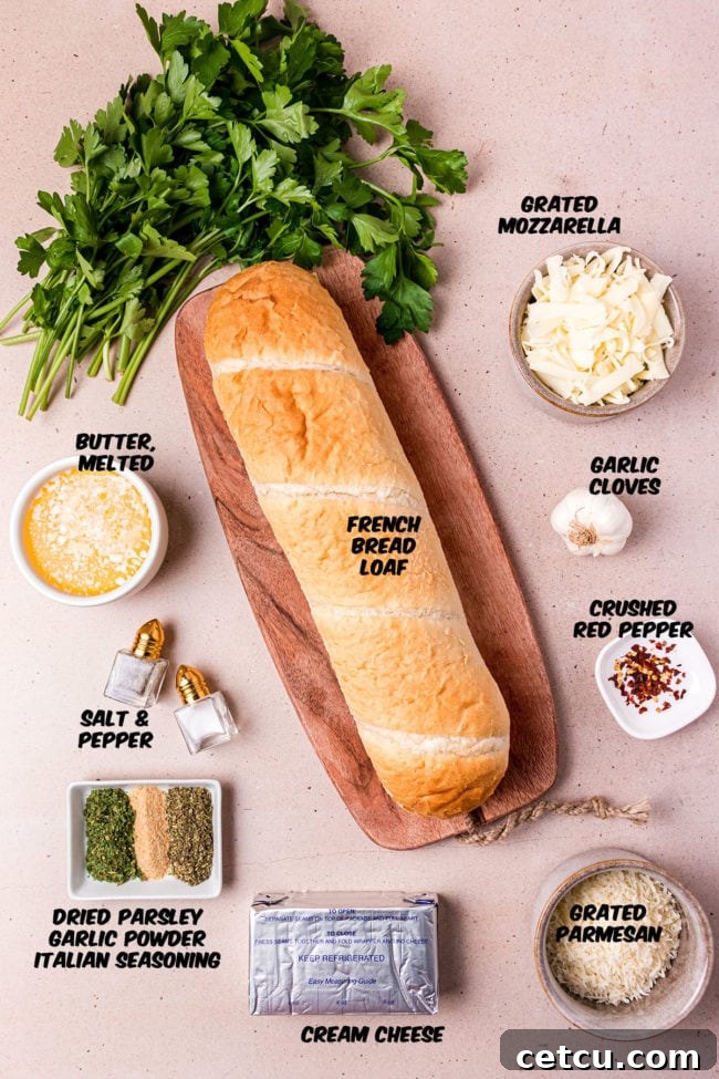 Assortment of fresh ingredients laid out, including French bread, butter, various cheeses, and seasonings, ready for making garlic cheese bread.
