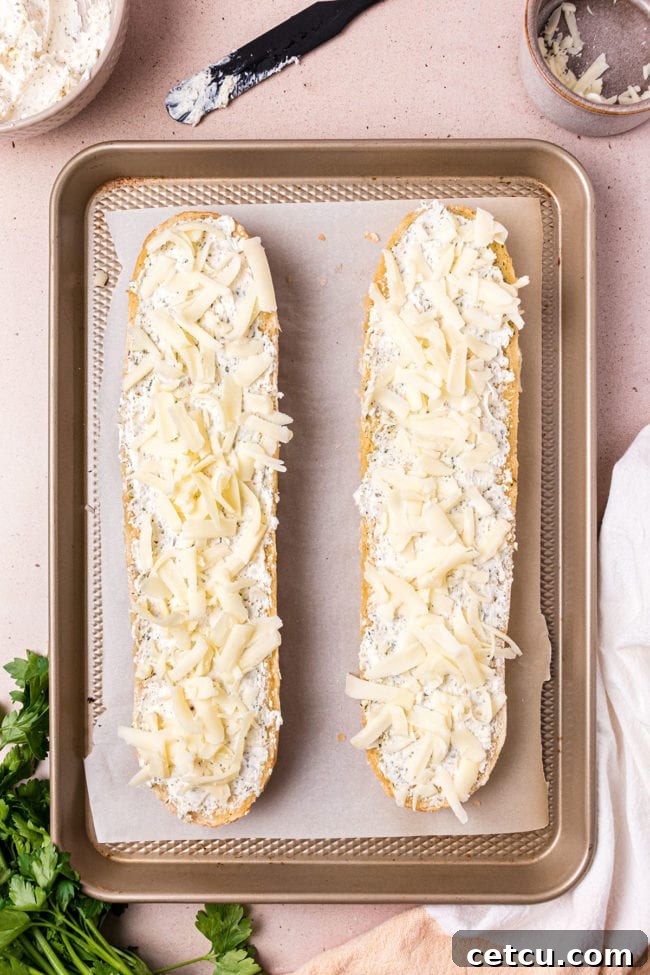French bread halves topped with the creamy cheese spread and a layer of mozzarella, prepared for final broiling.