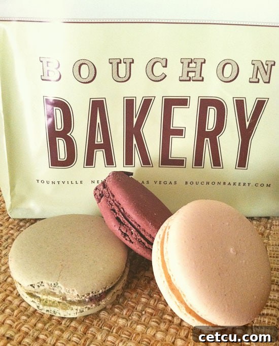 Bouchon Bakery macarons at TidyMom.net, a close-up of beautifully arranged macarons on a display stand, highlighting their vibrant colors and delicate meringue shells.