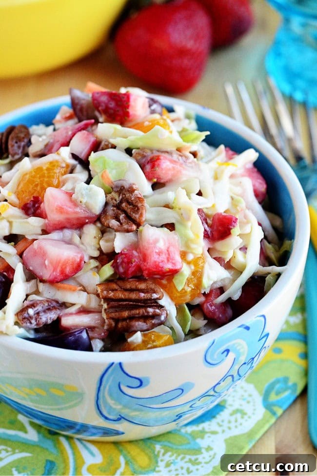 Fresh and vibrant Fruit and Nut Slaw, a cool side dish with strawberries, grapes, and mandarin oranges, dressed in a light slaw dressing with pecans and blue cheese. Perfect for a summer BBQ or picnic.