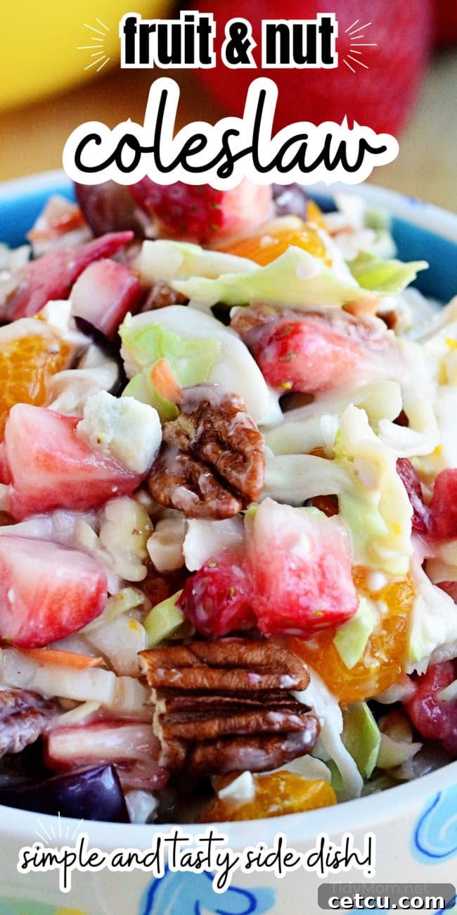Beautiful Fruit and Nut Slaw served in a blue bowl, garnished and ready for serving.