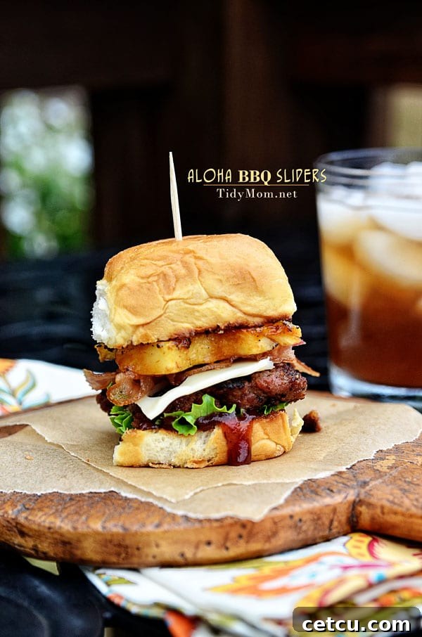 Fire up the grill for this Hawaiian burger recipe. Aloha BBQ Sliders are flavored with BBQ sauce, served on sweet rolls with cheese, pineapple and bacon. Aloha BBQ Sliders recipe at TidyMom.net