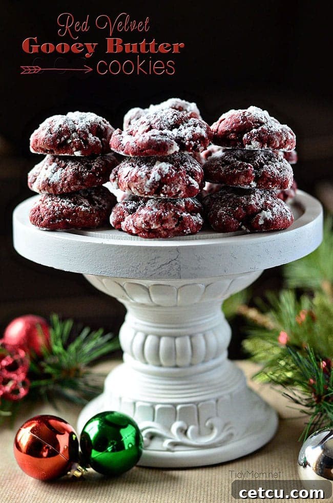 Stacked Red Velvet Gooey Butter Cookies dusted with powdered sugar, ready for Christmas