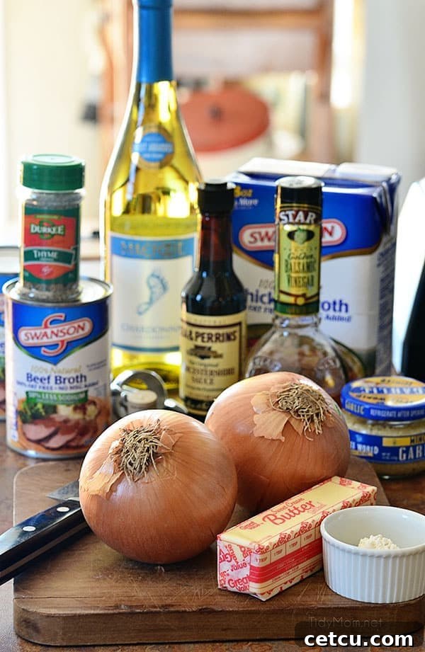 Fresh ingredients laid out for making French Onion Soup, including sliced onions, herbs, and cheese.
