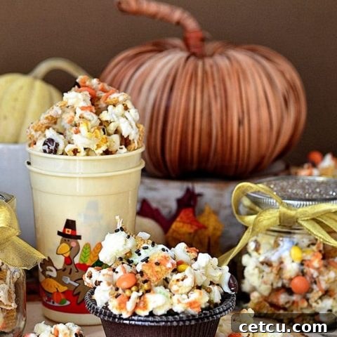 Turkey Munch - Fall Popcorn Snack Mix with bugles, reeses pieces and sprinkles all drizzled in white chocolate and pumpkin candy melts. Recipe at Tidymom.net