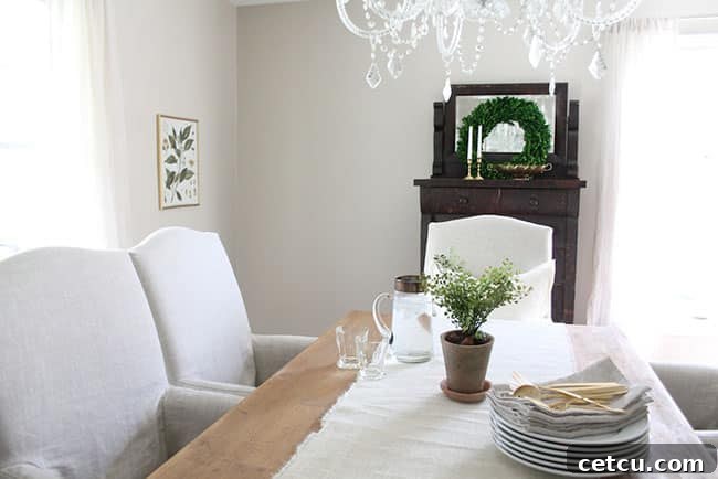 Mastering the White Home: Smart Storage for Pristine Living 7 White Dining Room with Antique Dresser and Versatile Bar Cart