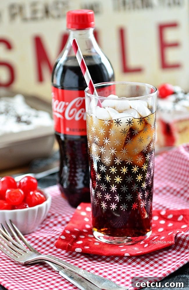 A perfectly poured glass of Coca-Cola with ice, ready to be enjoyed at a festive game day event.